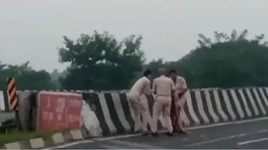 Indian policemen caught on camera throwing accident victim's body into canal 